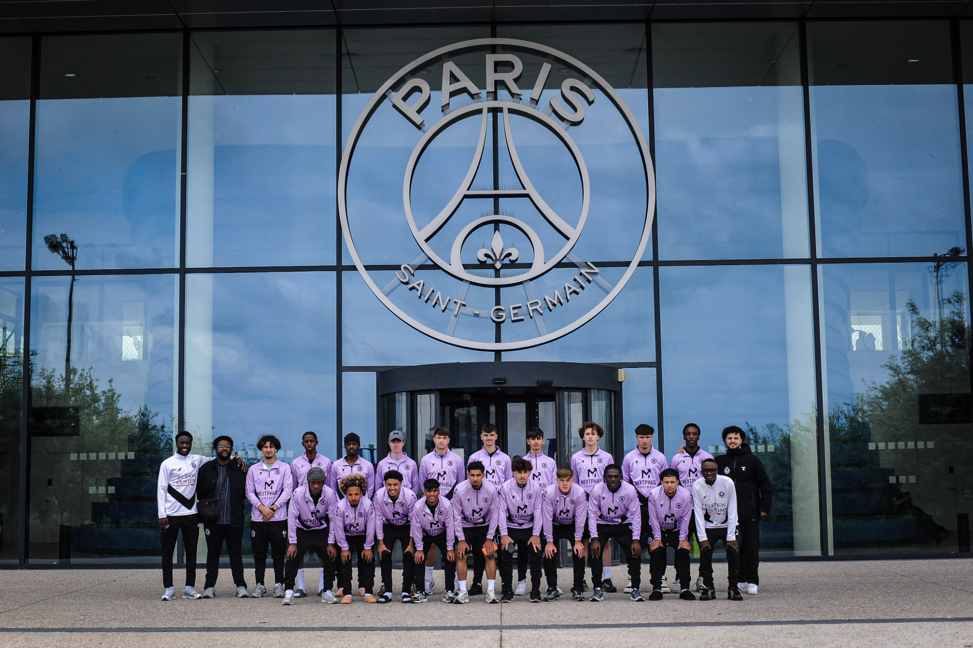 The Next Phase Football squad photographed outside the Paris Saint-Germain training facility.