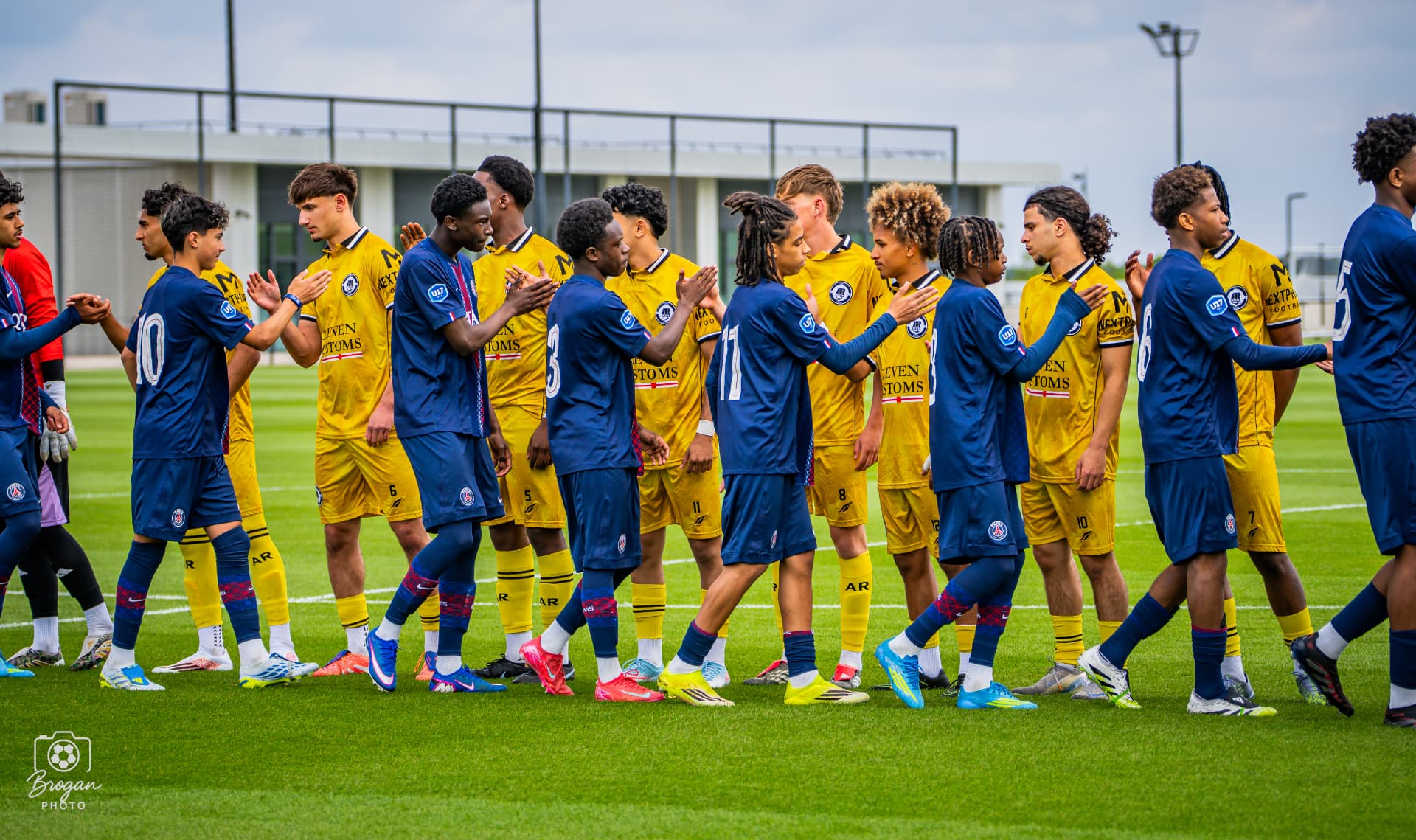 Next Phase Football players shaking hands with Paris Saint-Germain youth players after a competitive fixture.